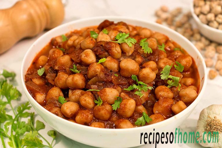 chana masala recipe serve on white bowl garnish with chopped coriander leaves