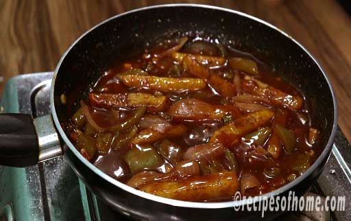 gently mix fried potatoes in chilli gravy
